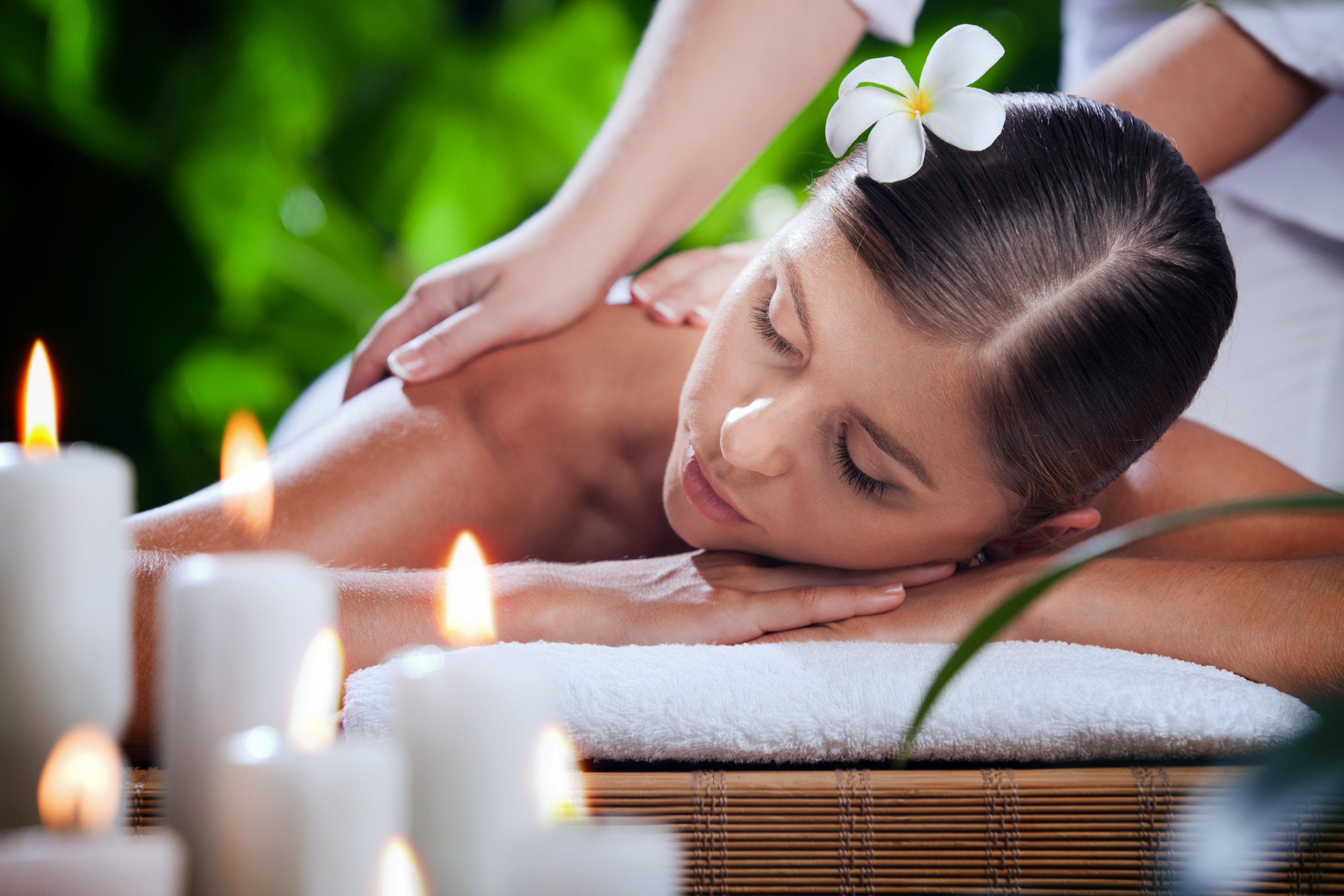A woman receiving a relaxing back massage at a luxurious spa.