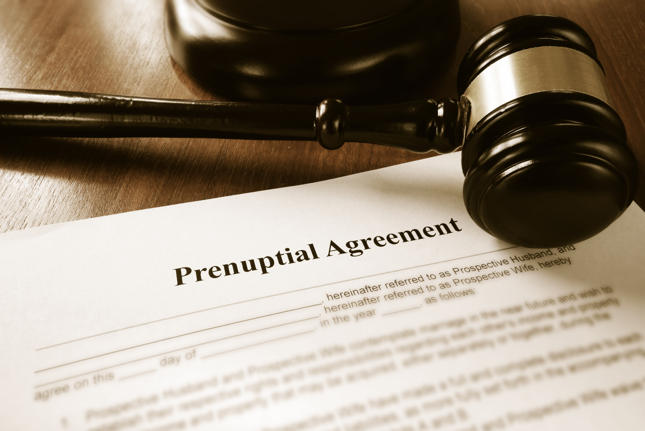 A professional male attorney consulting with a female client in a modern law office setting.