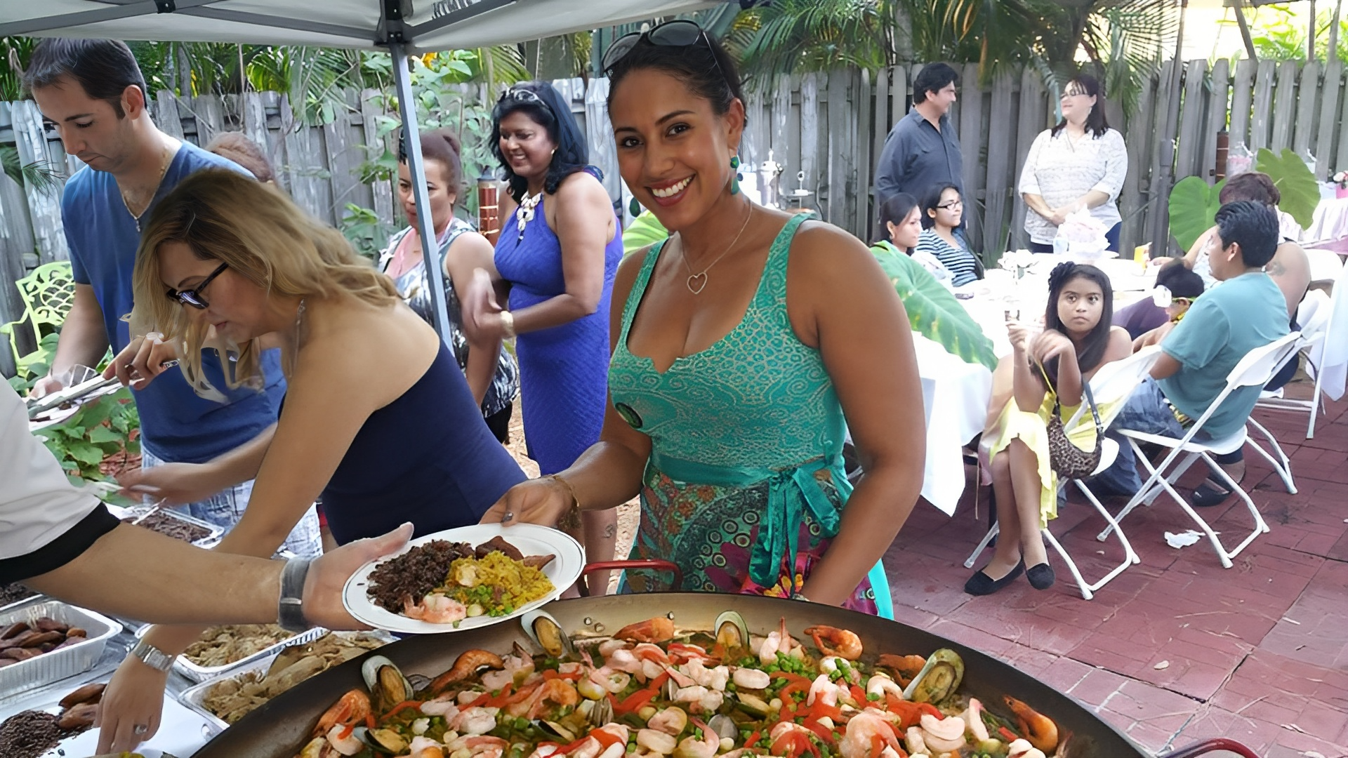 A chef preparing a traditional Spanish paella dish at an outdoor event in Florida Keys.