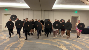 Valkyrie Training bootcamp in person class with exercise training swords and shield doing a shield wall with the instructor.