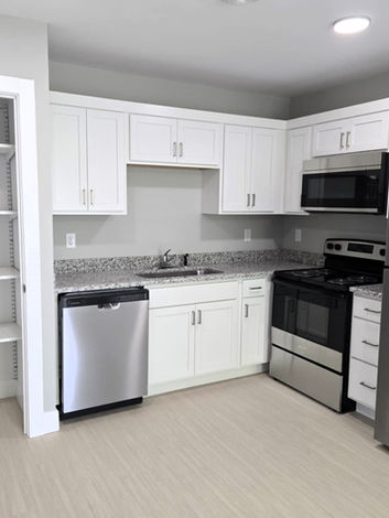 Spacious, open kitchen with modern appliances and finishes at Auburn Meadows in Auburn, MI