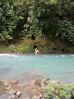 Sitting on a mossy bank of Rio Celeste