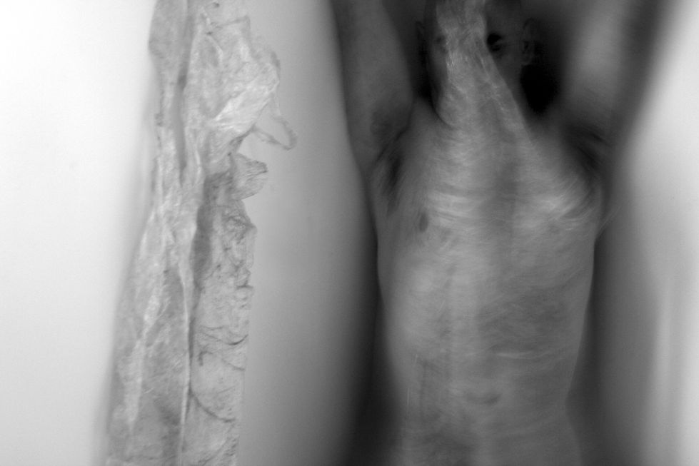 Blurry B&W photography, figure peeling out of a second skin