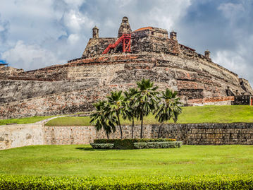 Historic fortress with lush green grass and cloudy sky DREAMWORTHY DESTINATIONS for travel.