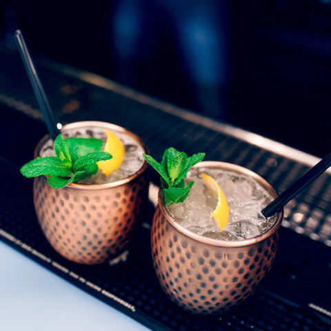 10. Golden vase exotic healthy Cocktail drink with burning cinnamon and lime, mint beverag
