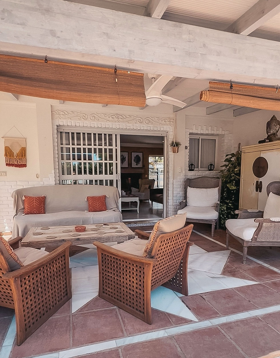 Eye-level view of a boho-style outdoor seating area surrounded by greenery