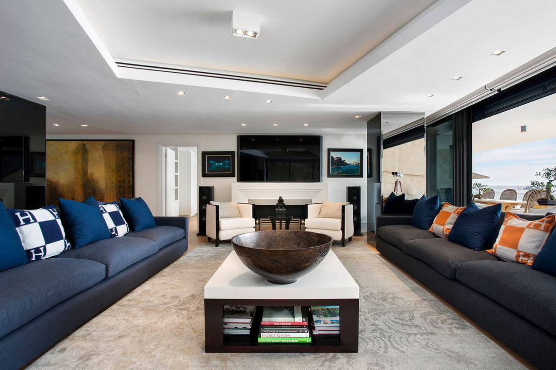 A luxurious lounge with high-quality furniture and Hermès cushions, interior design by Smit Collective in Clifton, Cape Town.