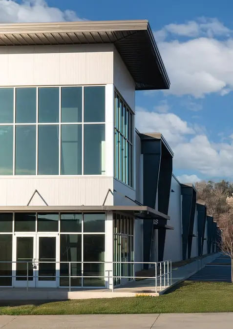 Exterior commercial and industrial painting on metal panel and EIFS facade at 100 Riverport Road industrial facility, Chattanooga, TN, by Dream Team Finishes