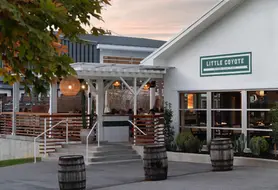 Exterior entrance of Little Coyote restaurant at dusk in Historic St. Elmo, Chattanooga, TN, commercial painting and specialty finishes by Dream Team Finishes