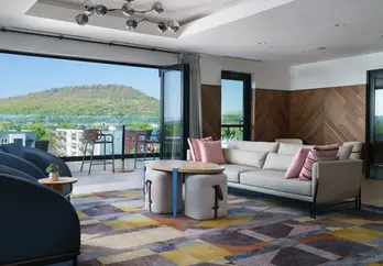 Rooftop terrace at Caption by Hyatt Chattanooga at sunset, featuring painted brick exterior walls finished by Dream Team Finishes and panoramic views of the Chattanooga skyline and mountains.