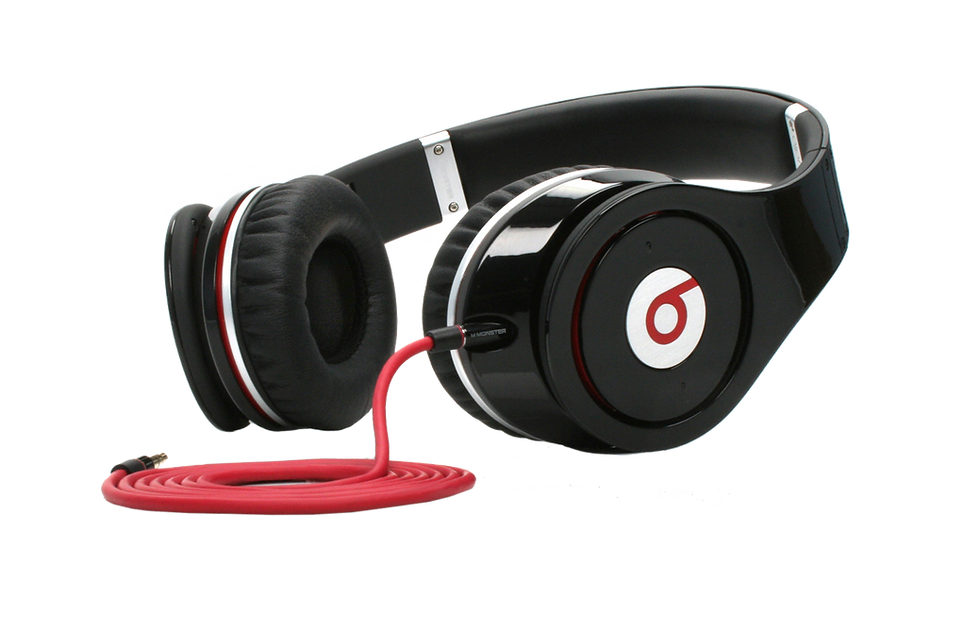 Black over-ear headphones with red logo and coiled cable
