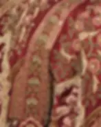 A red fabric with flower and parrot motif embroidery