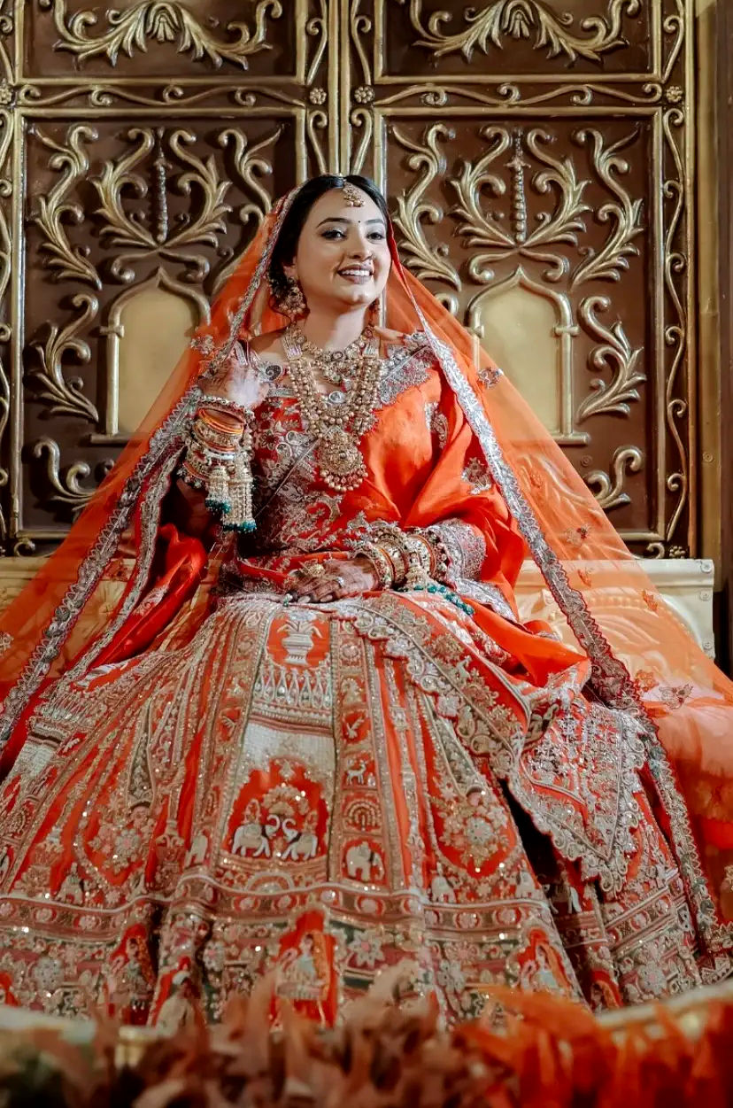 Beyond bridal trend, a bride in a orange lehenga