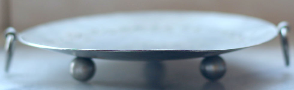 Thumbnail: Round metal tray or platter with a central floral engraving and vine-like border