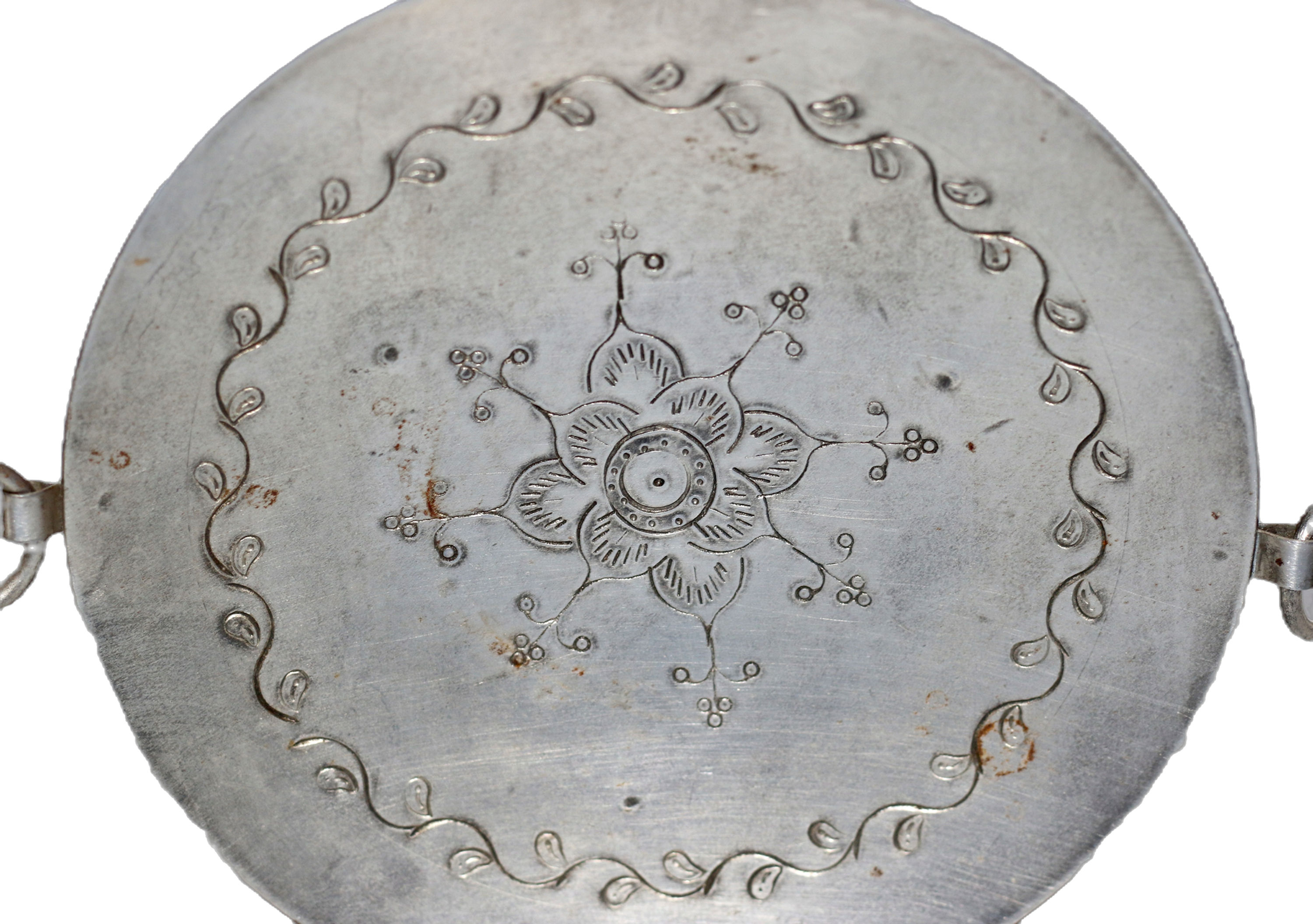 Round metal tray or platter with a central floral engraving and vine-like border