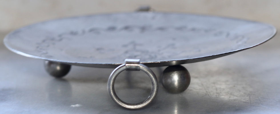 Thumbnail: Round metal tray or platter with a central floral engraving and vine-like border