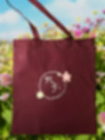 Flowers featured behind to Made2Fit's Spring embroidered tote bag