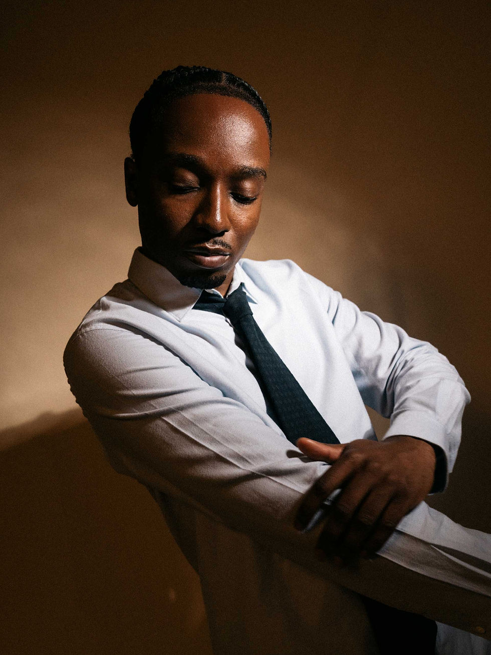 Kwabena Peprah in a white shirt and tie during a studio portrait for The Guide Magazine
