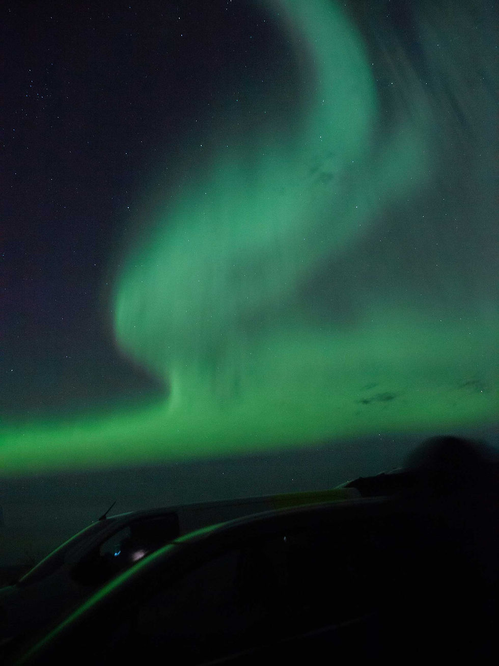 Northern Lights illuminating the night sky above the Tromsø.