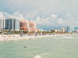 Wide view of Clearwater Beach on Florida’s Gulf Coast with beachfront hotels, turquoise water and people relaxing along the shoreline