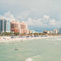 Wide view of Clearwater Beach on Florida’s Gulf Coast with beachfront hotels, turquoise water and people relaxing along the shoreline