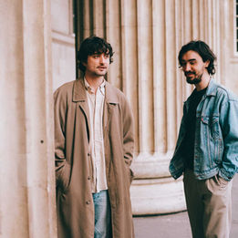 Flyte band members Will Taylor and Nick Hill outside a neoclassical building in London (Photo by Katie Silvester)
