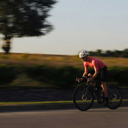 Road cyclist riding at speed on an open countryside road