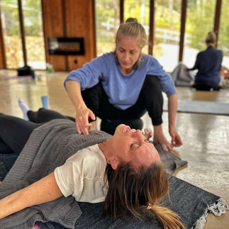 A participant in a Somagetic Practitioner Training guides an Ecstatic Experience session, deepening their ability to hold space for energy flow and emotional release.