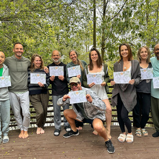 A group of newly certified Somagetic practitioners in San Diego, USA, holding their certificates in celebration.