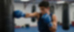 Boxer hitting a punching bag in a gym