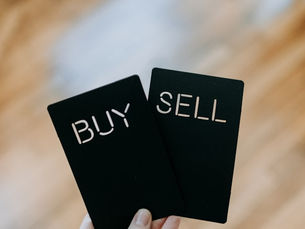Two black cards with the words "Buy" and "Sell" on them