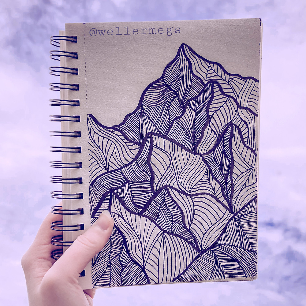 Mountain drawing done with micron pens, sitting against a cloud background.