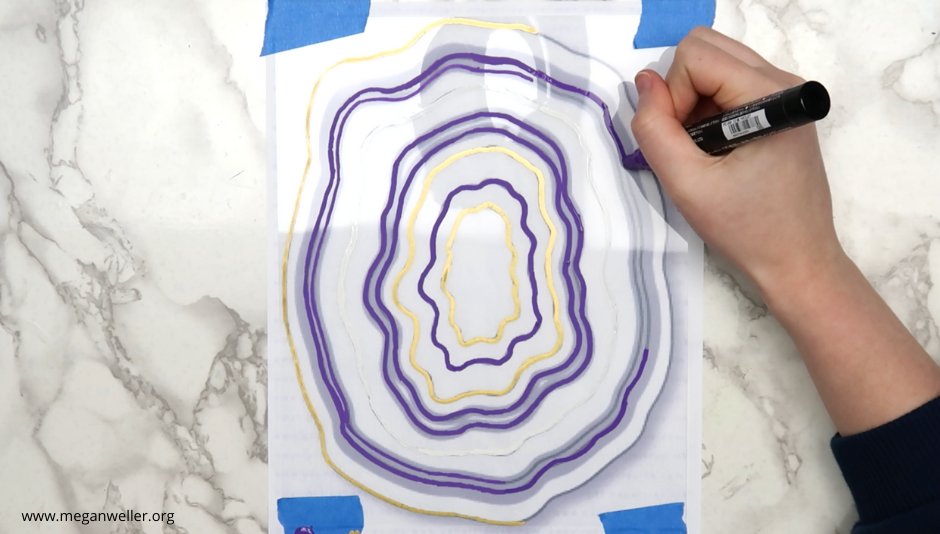 Trace the outline of the geode with purple, gold, and white Posca Pens.