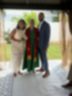 Couple with officiant and simple wedding decorations