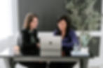 Two immigration attorneys reviewing case strategy for clients' EB-1 and NIW green card processes