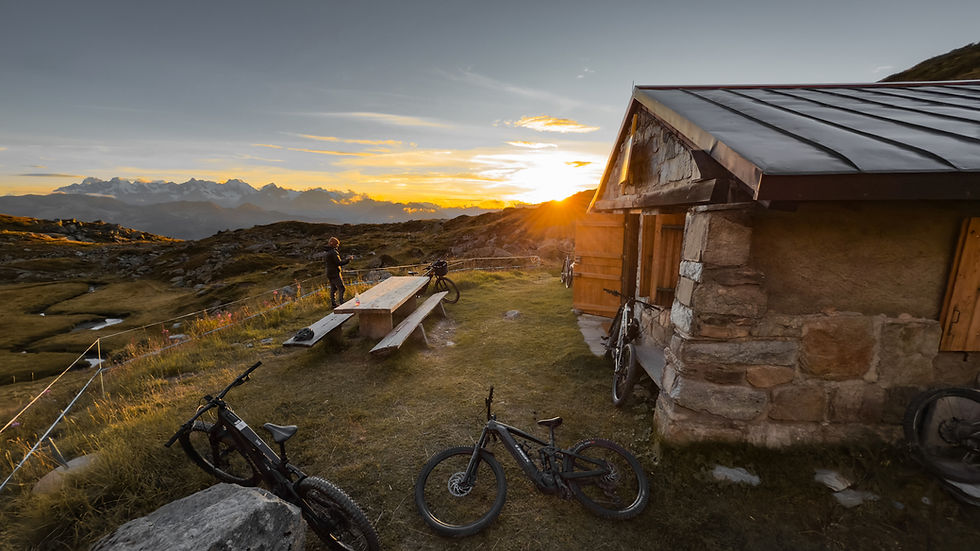A client riding a scenic singletrack trail on an E-Bike with PureBiking Verbier guides.