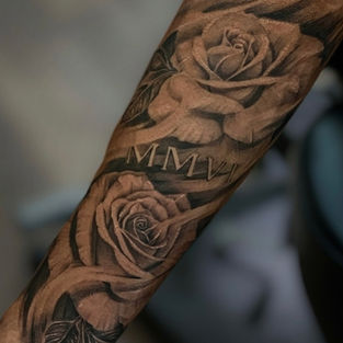 forearm sleeve of realistic roses tattoo