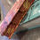 Thumbnail: Copper and Red Marbled Journal Displayed over a book on a wood table
