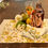 Thumbnail: Yellow green and white placemat with plates, wine glass, cutlery and napkin