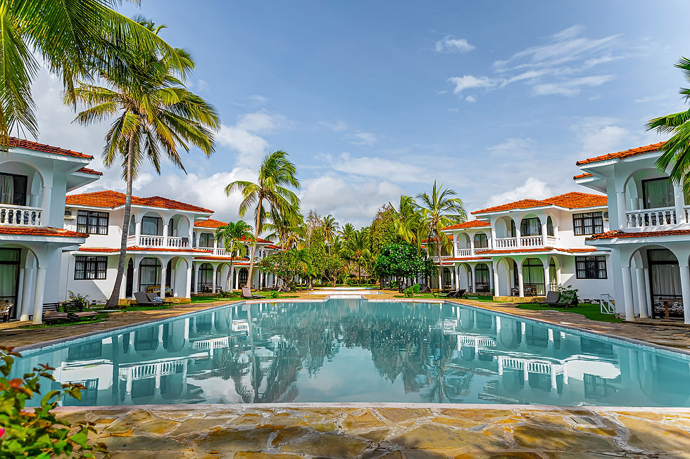 Stunning view of a luxury Caribbean resort with palm trees and a large pool, representing the serene and upscale experiences
