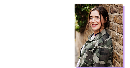 Claire Hill, a woman wearing a camouflage jacket smiling at the camera, leaning against a brick wall
