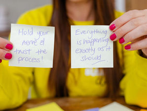Two post it notes saying 'hold your nerve & trust the process. Everything is happening as it should'