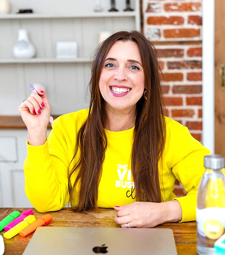 Claire Hill smiling in a yellow vivid business club jumper