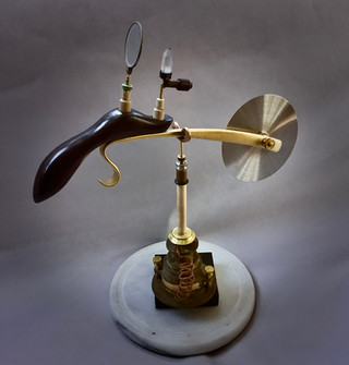 Handmade pizza cutter, Ebony handle with focusing lens, crystal and energy projection nozzle; hand forged brass blade mount arm. 1875