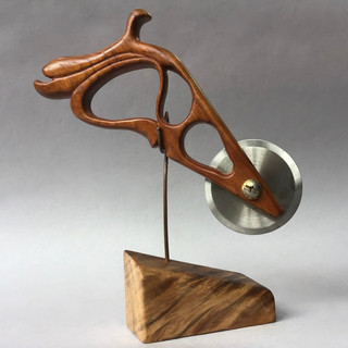 Pizza cutter handmade exotic tropical wood frame carved in form of a Bellanca Type A airfoil designed by G. Bellanca; Koa wood stand. 1916.