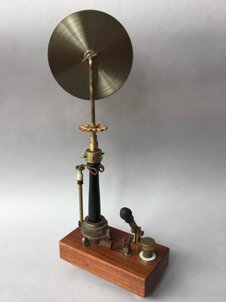 Pizza cutter handmade by Nikola Tesla; turned ebony handle with brass fittings on wood charging base with copper switch and brass dial. 1895