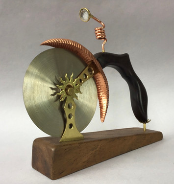 Handmade pizza cutter Rosewood handle with brass, copper & glass fittings in form of a single wheel bike with lamp; Koa wood stand. 1905