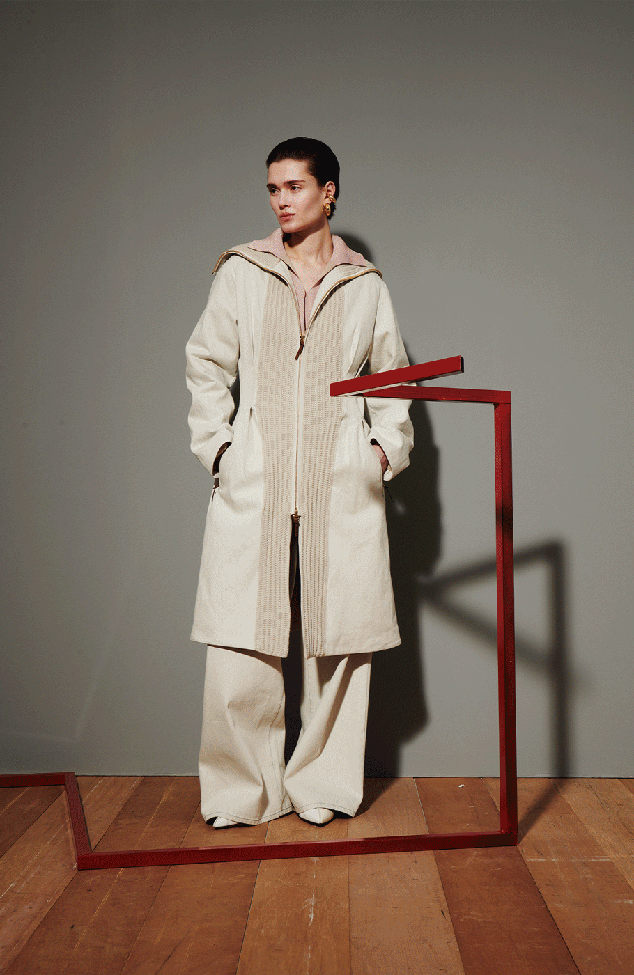Cividini Runway Fall Winter 2025 collection gif, showing a model sporting white and beige dresses, white and black coats, and taupe top and skirts.