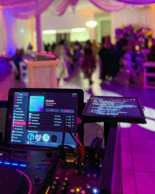 Eye-level view of DJ booth with professional sound equipment at a corporate event