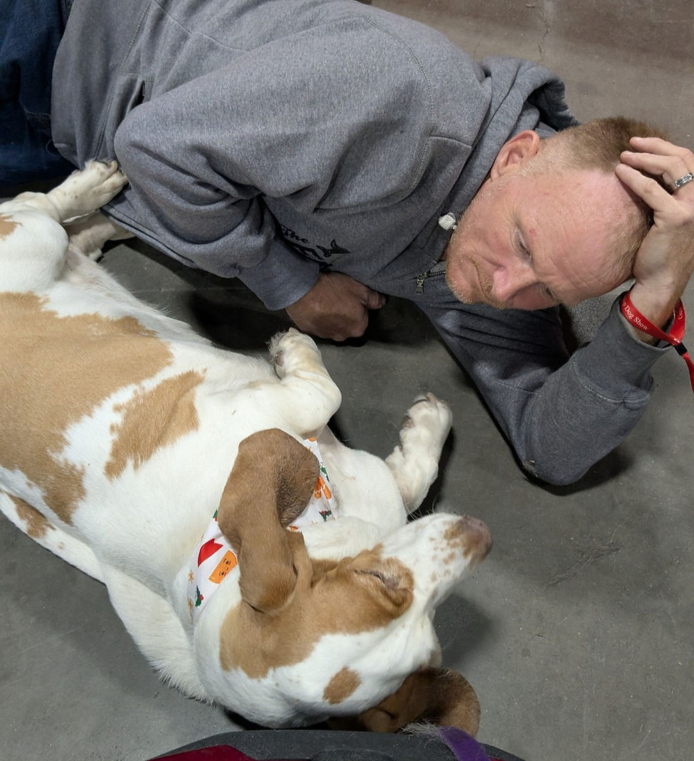 basset hound and man laying on the floor